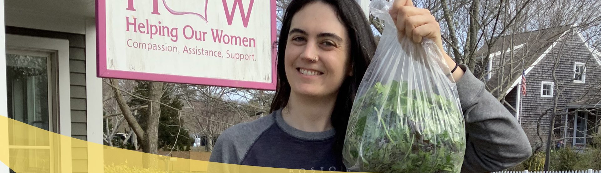 woman volunteer at HOW with bag of groceries